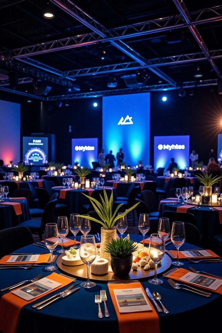 elegant party ambiance dimly lit banquet hall with blue tablecloths and candles